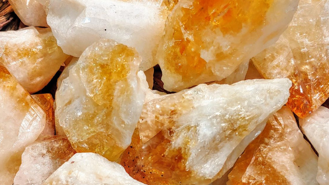 Raw citrine stones with natural textures and warm colors, highlighting the organic beauty of the November birthstone