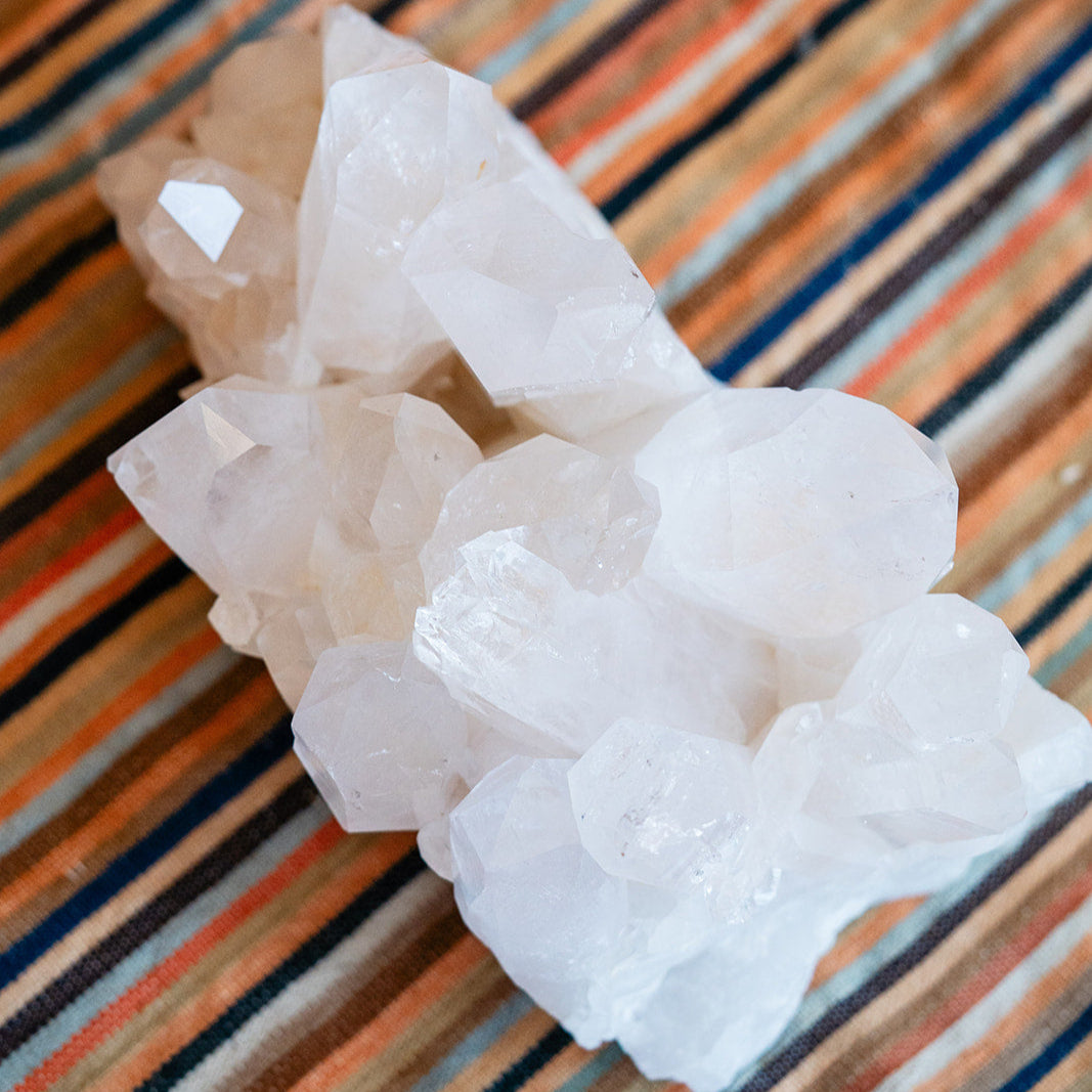 Crystal cluster on a striped fabric background