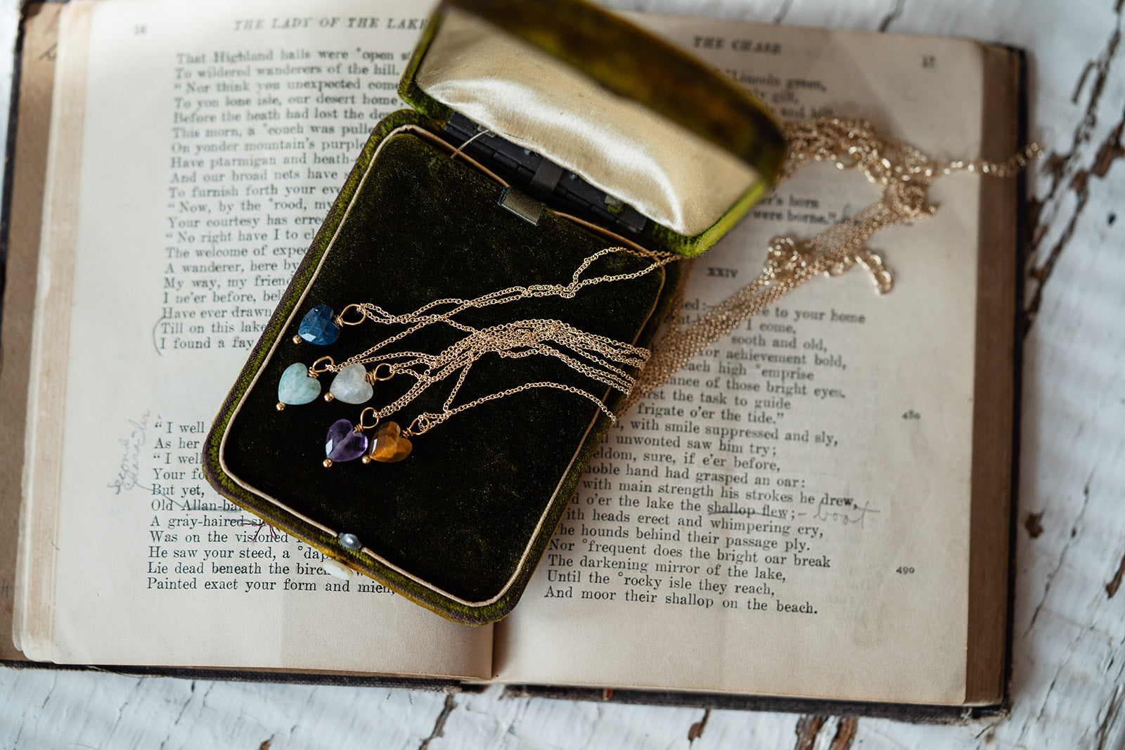 Jewelry box with necklaces on an open book