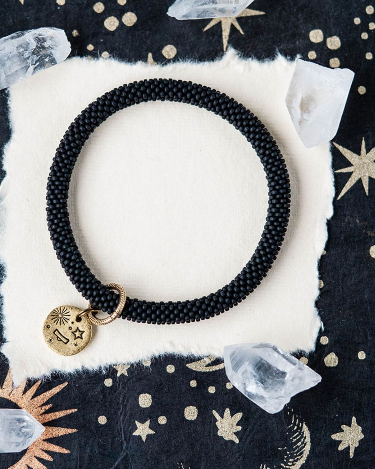 Black beaded bracelet with gold Libra zodiac pendant styled with crystals and stars