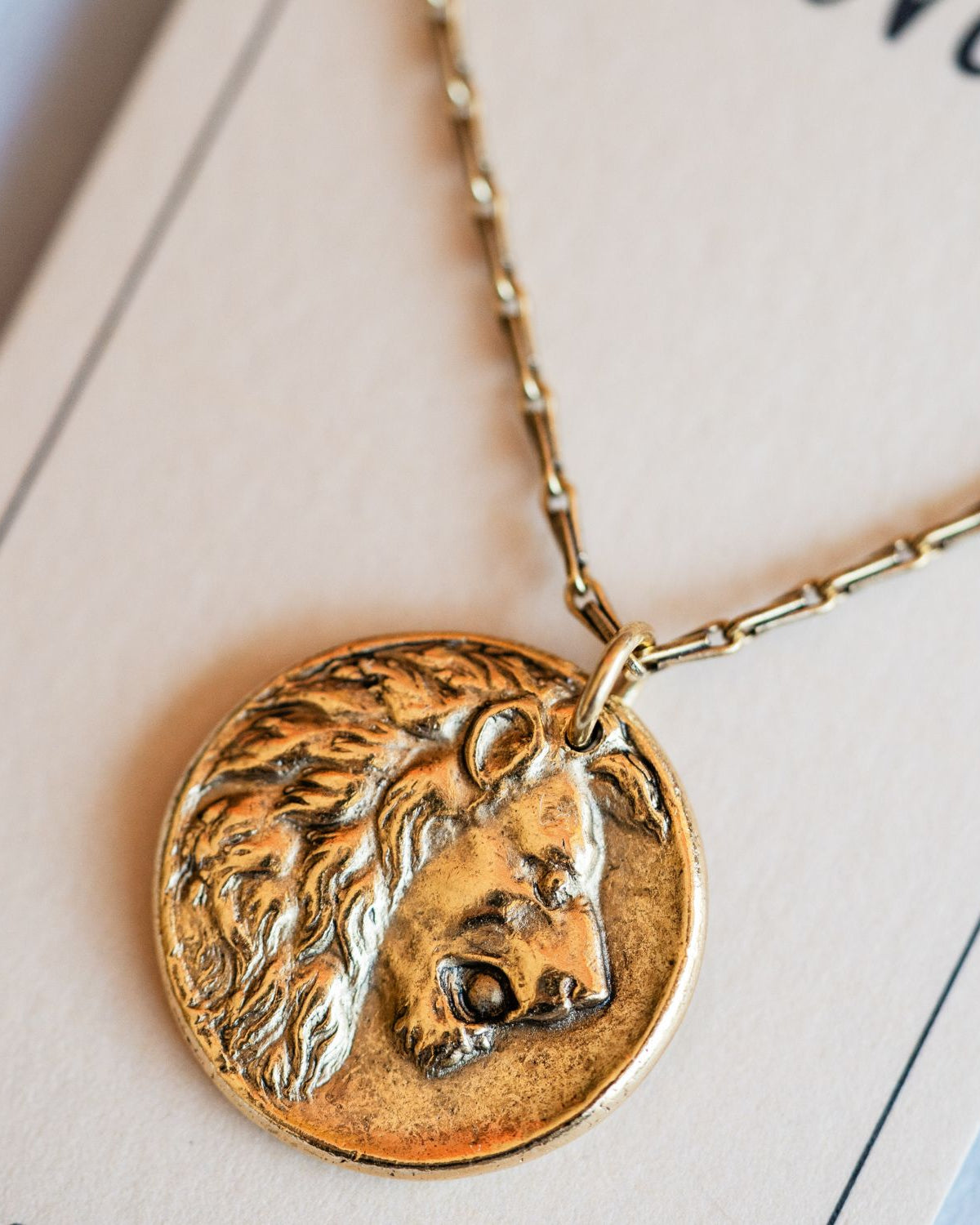 Cast gold lion pendant necklace from antique button design by Bella Vita Jewelry artisans