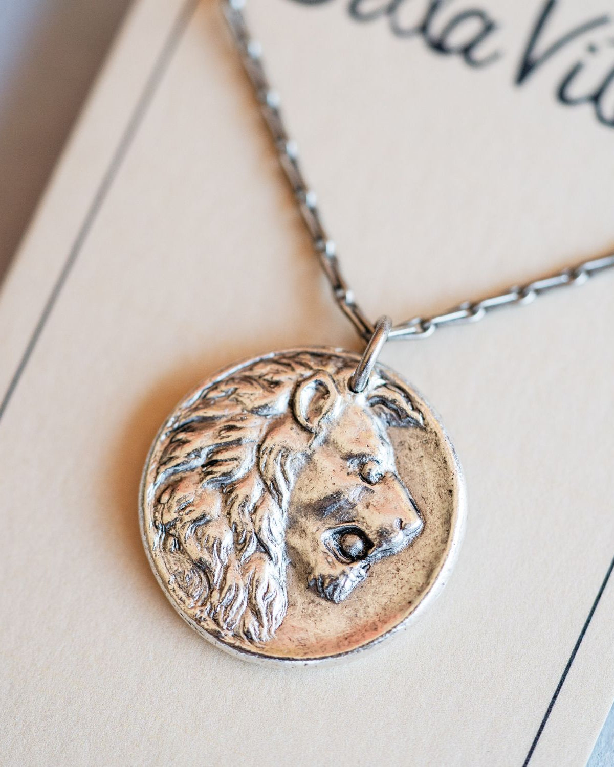 Artisan silver lion pendant necklace featuring vintage button casting by Bella Vita Jewelry