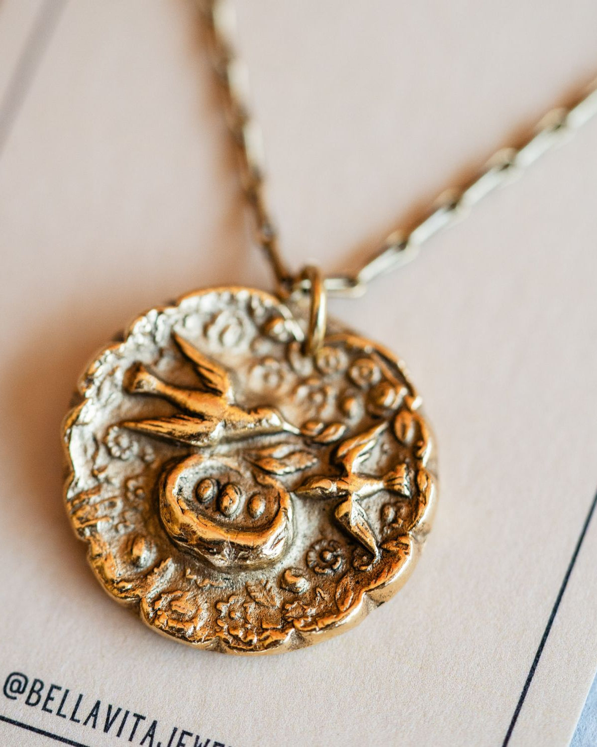 Artisan gold mama bird pendant necklace featuring vintage motherhood button casting