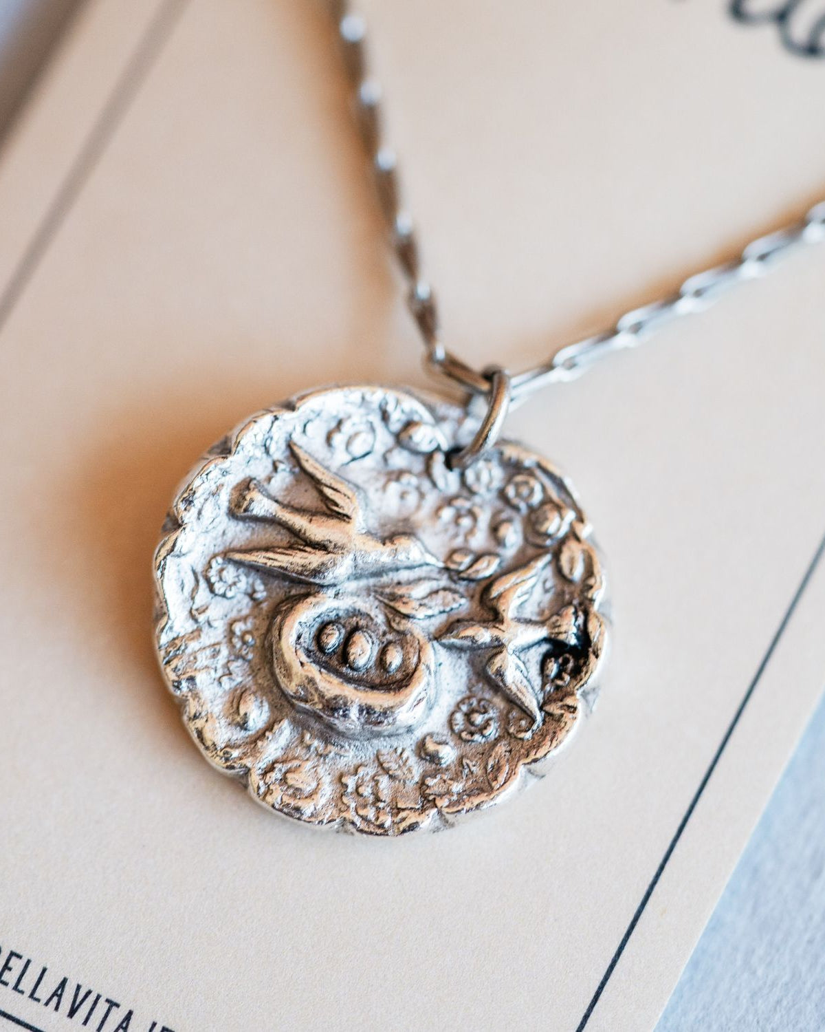 Cast silver mama bird pendant from antique button design by Bella Vita Jewelry