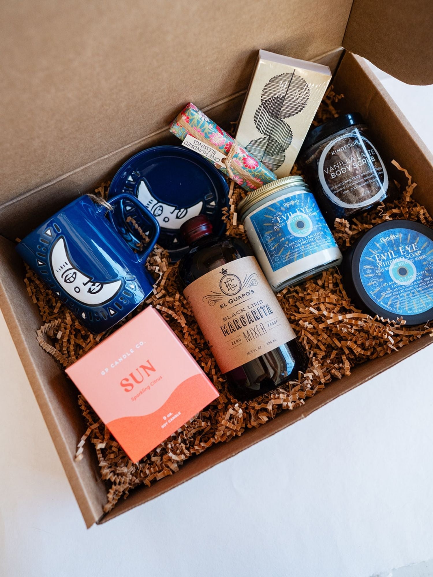 Close-up of Bella Vita self-care box featuring Evil Eye body products, handcrafted items, and wellness gifts in eco-friendly packaging