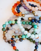 Collection of colorful gemstone Good Vibes bracelets