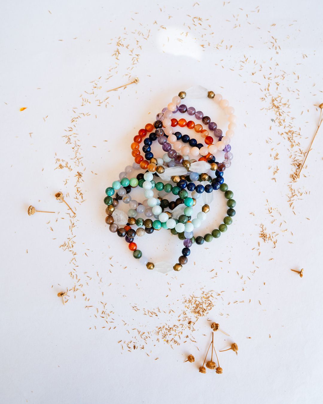 Flatlay of Good Vibes bracelets with various gemstones