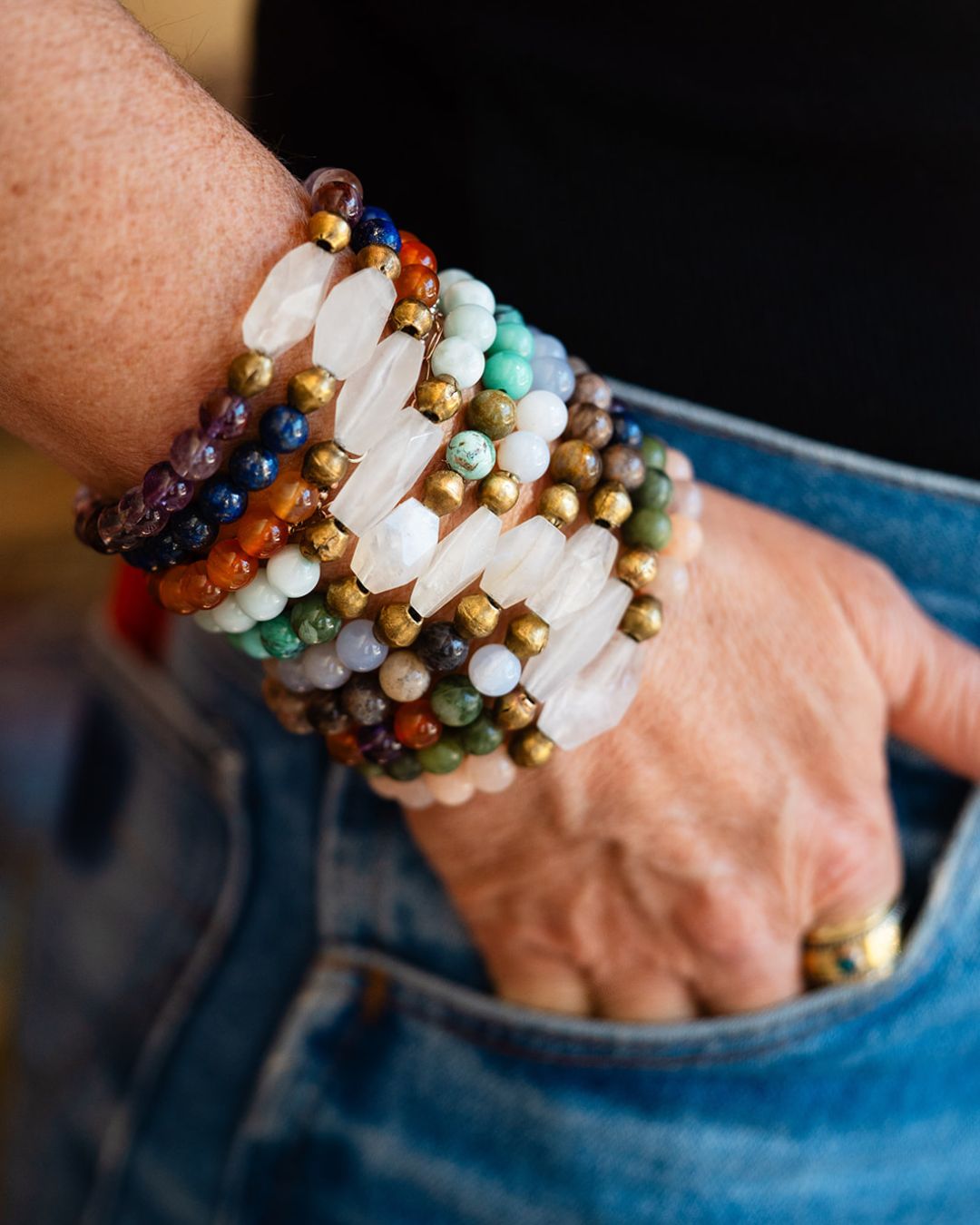 Multiple Good Vibes bracelets stacked on wrist