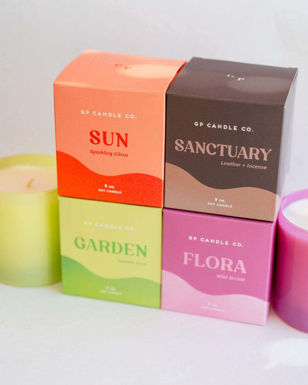 GP Candle Co. luxury soy candle collection featuring Sun, Sanctuary, Garden, and Flora boxes with matching colored candles