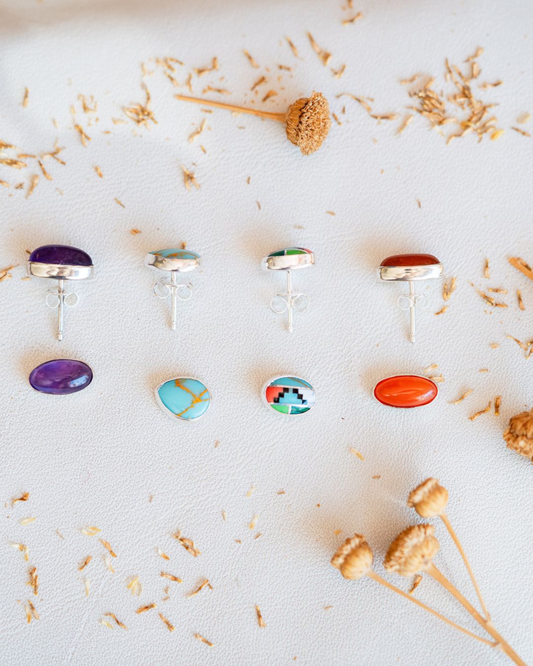 Sterling silver stud earrings featuring amethyst, turquoise, southwest pattern, and carnelian gemstones