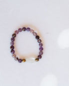 Super 7 bracelet with purple gemstone beads and clear quartz accent