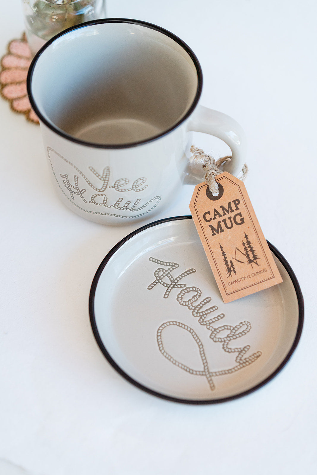 Cream Cuppa Color ceramic 'Howdy' mug and coaster with contrasting black rim, handcrafted premium western-inspired design.