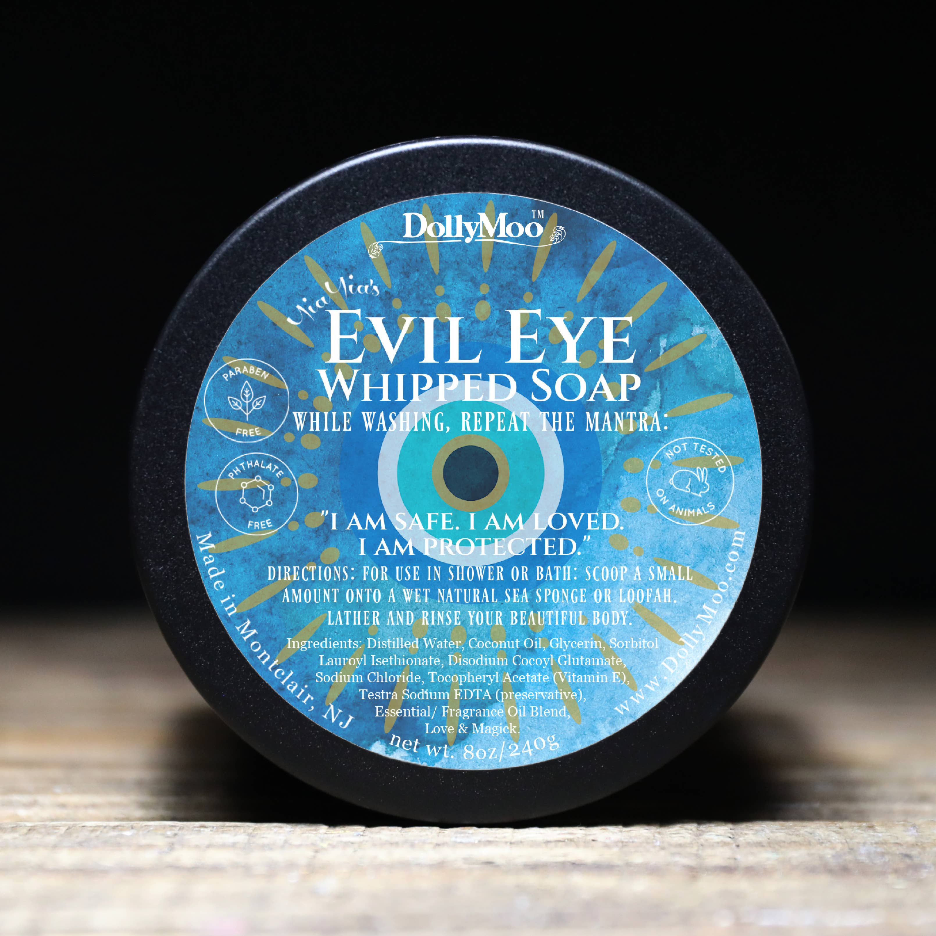 DollyMoo Evil Eye Whipped Soap in circular container featuring traditional blue Evil Eye protection symbol with affirmation 'I am safe, I am loved, I am protected' and coconut oil-based cleansing formula.