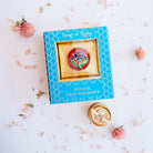 Song of India Relax natural solid fragrance in turquoise box with embossed gold pattern, featuring red brass container with blue floral design.