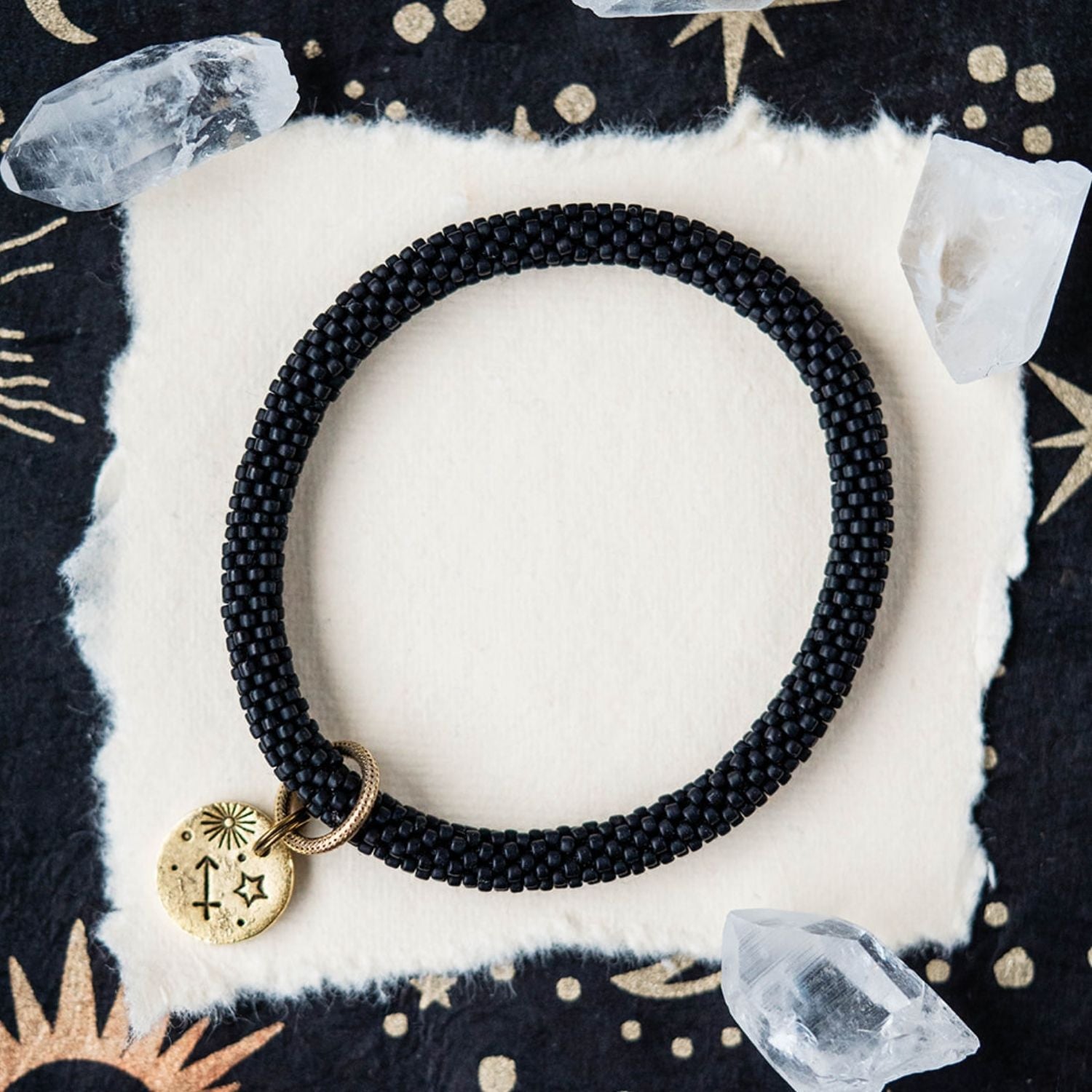 Black beaded bracelet with gold Sagittarius zodiac pendant styled with crystals and stars