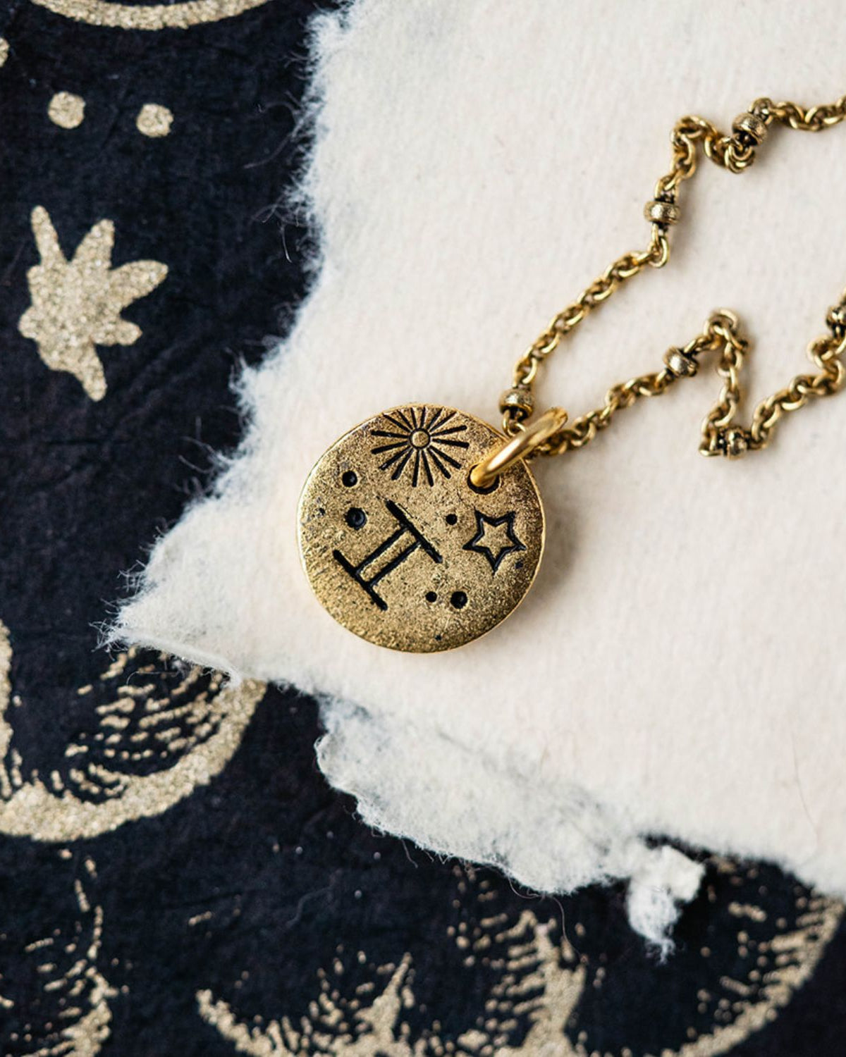 Gold Gemini zodiac pendant necklace with twins symbol and celestial engravings on chain