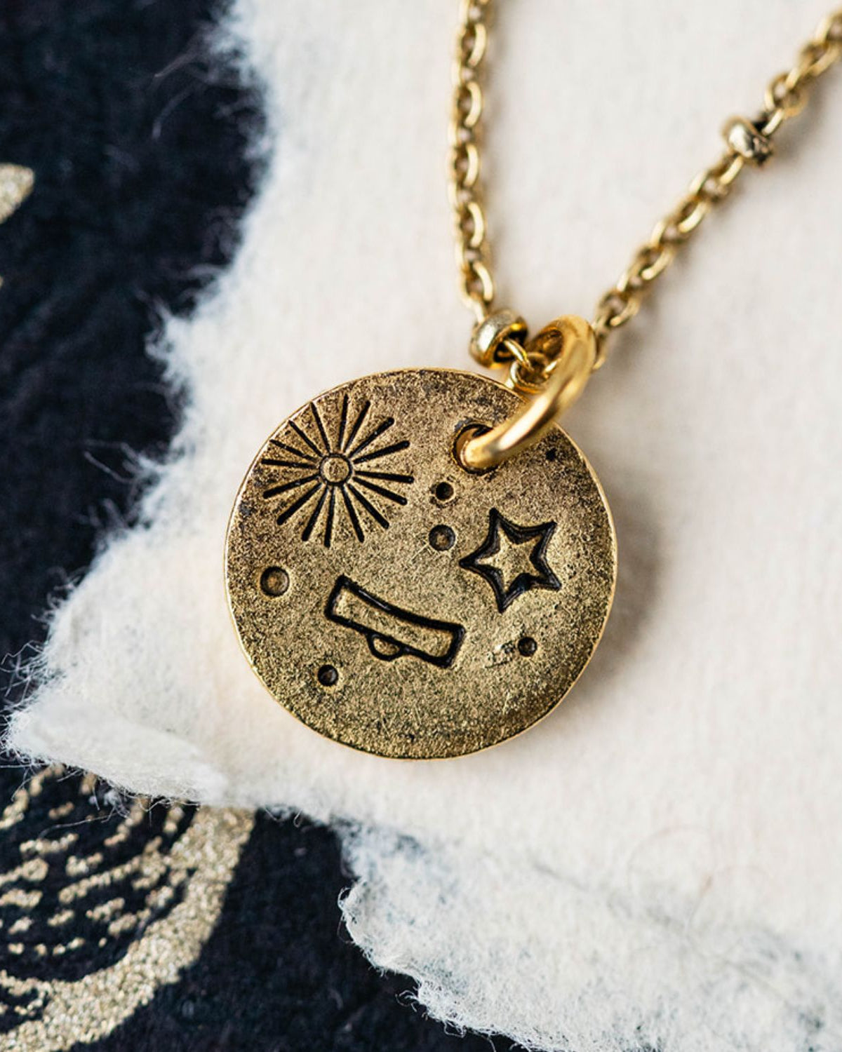Gold Libra zodiac pendant necklace with scales symbol and celestial engravings on chain