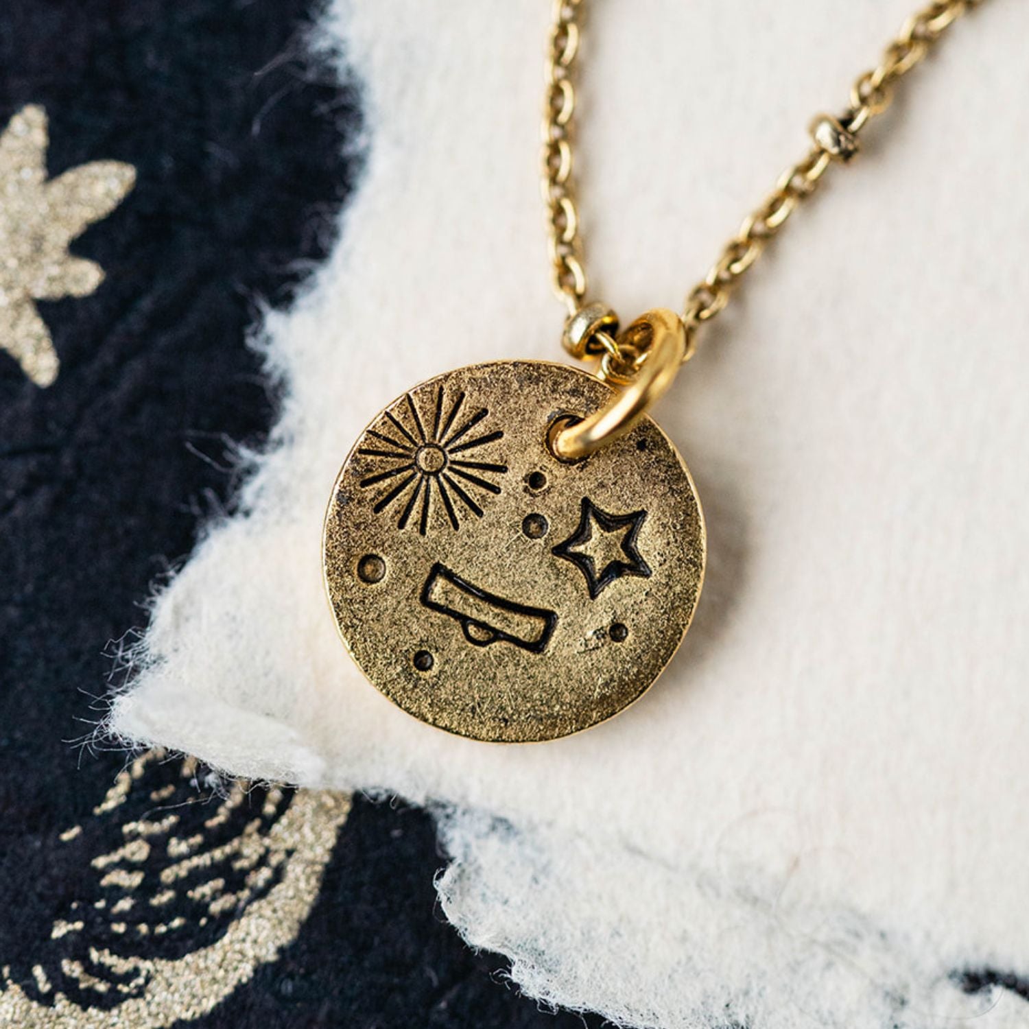 Gold Libra zodiac pendant necklace with scales symbol and celestial engravings on chain