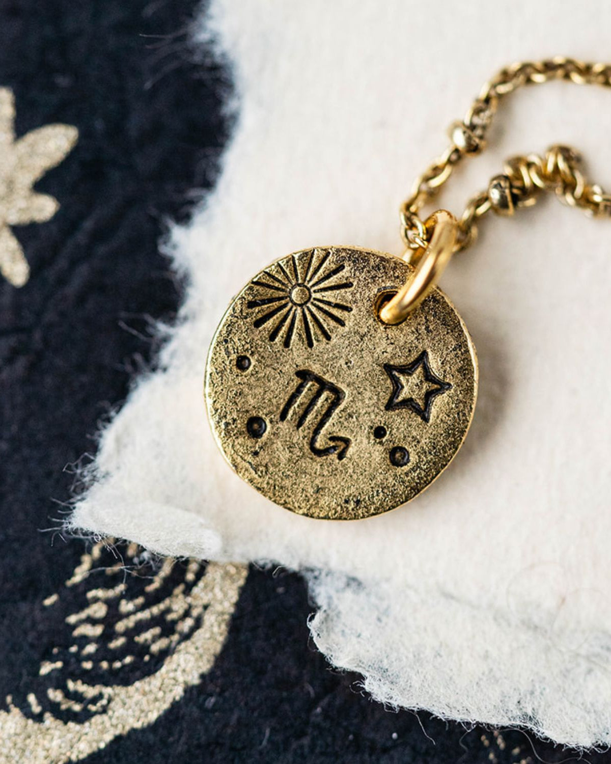 Gold chain necklace with Scorpio zodiac pendant featuring scorpion and celestial constellation symbols