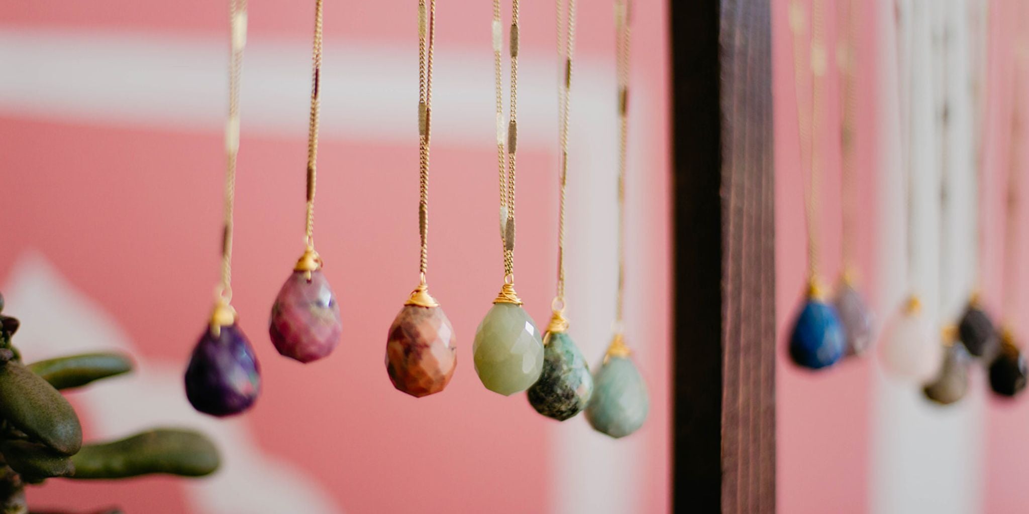 Close-up view of Bella Vita’s Zara Drop Necklaces in various natural stone colors, showcasing the handcrafted vintage charm and unique design. Perfect for holiday gifting.