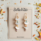 Bella Vita earrings on a branded card with dried flowers around
