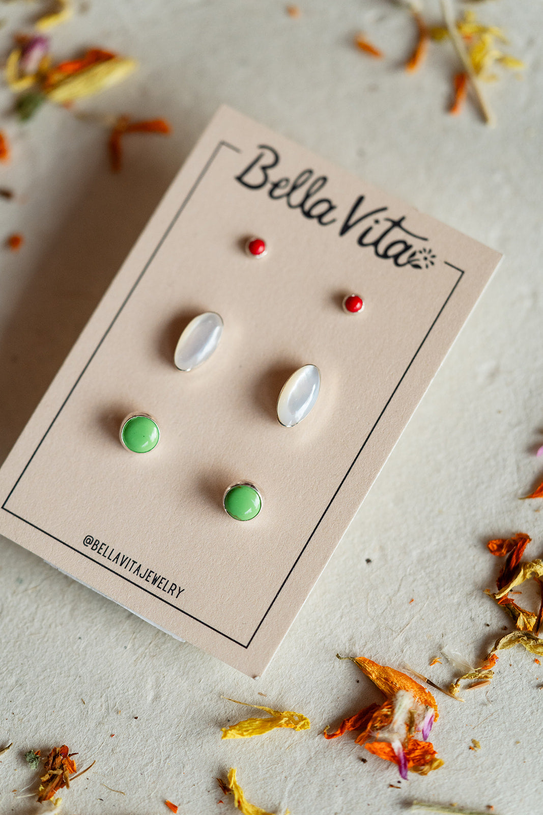 Bella Vita earrings on a branded card with dried flowers around