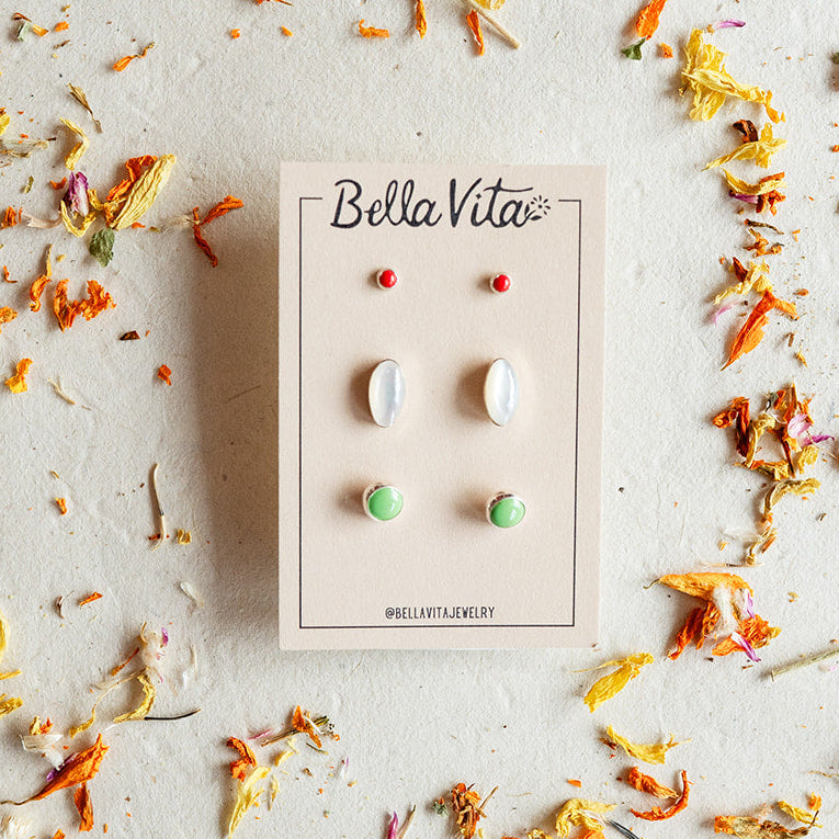 Bella Vita earrings in a box surrounded by dried flowers on a light background
