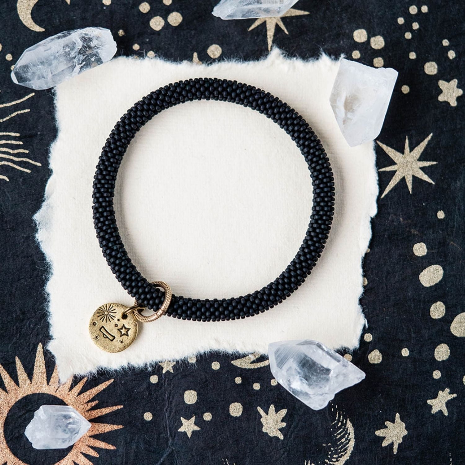 Black beaded bracelet with gold Libra zodiac pendant styled with crystals and stars