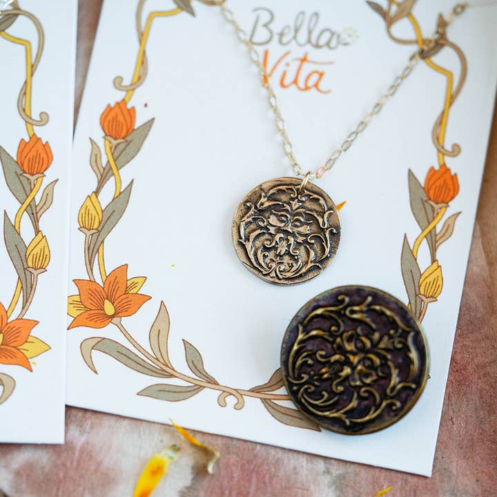 Art Nouveau Man Necklace displayed on a Bella Vita card, featuring a detailed bronze pendant with intricate Art Nouveau patterns.