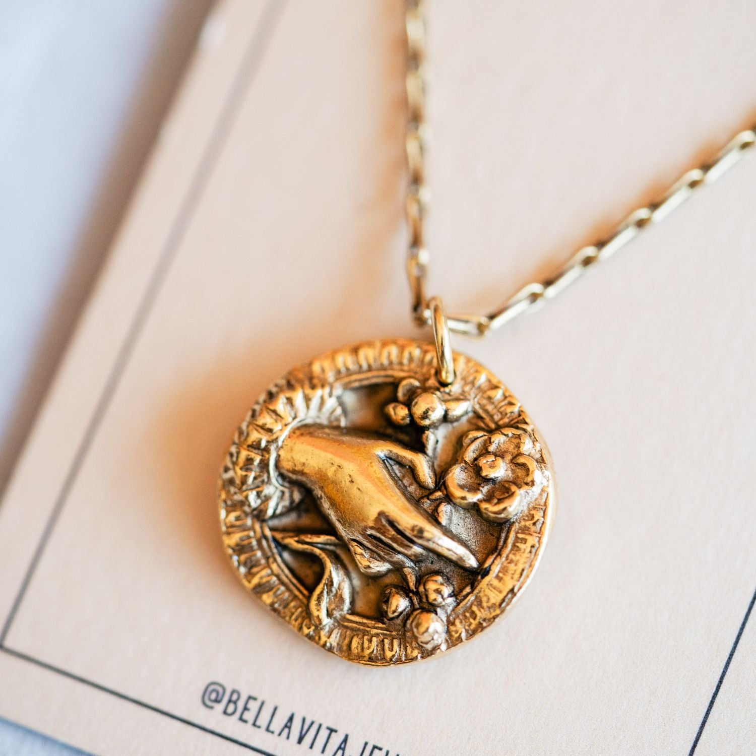 Artisan gold bouquet pendant necklace featuring vintage floral button casting by Bella Vita