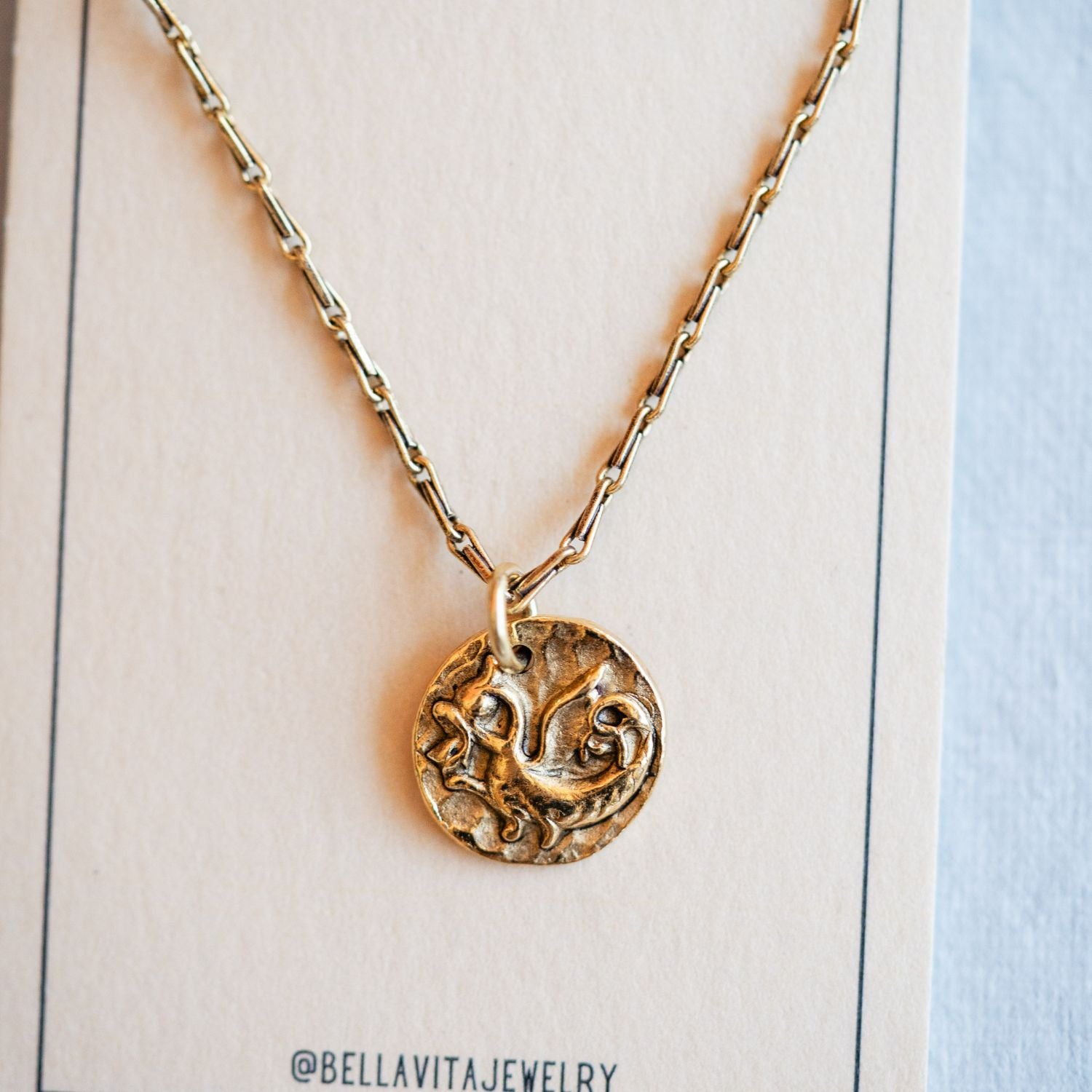Gold cast dragon heirloom pendant shown with Bella Vita artisan jewelry packaging