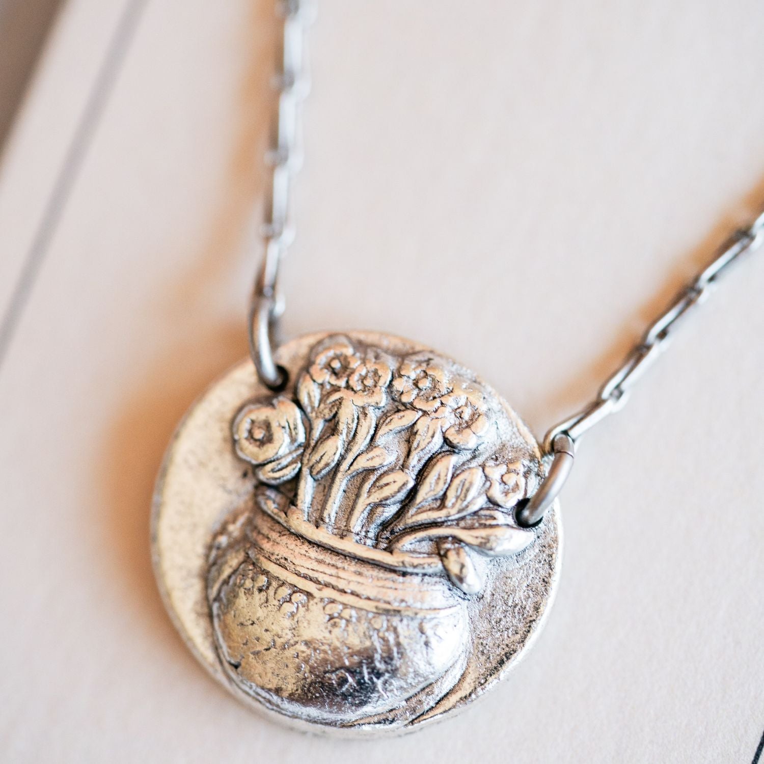 Cast silver flower pot pendant from antique garden button by Bella Vita Jewelry