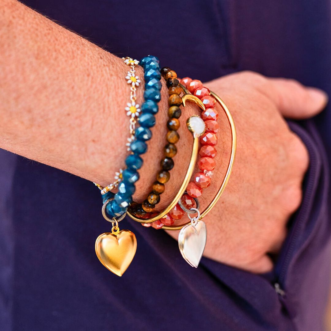 Bella Vita stacked bracelet set featuring blue crystal, tiger's eye, and coral beads with gold and silver heart charms