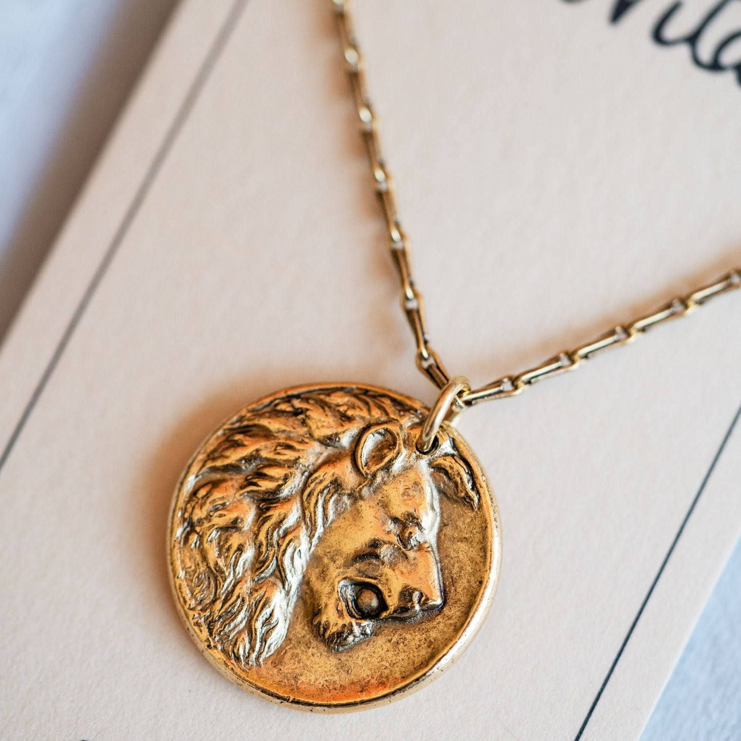 Cast gold lion pendant necklace from antique button design by Bella Vita Jewelry artisans
