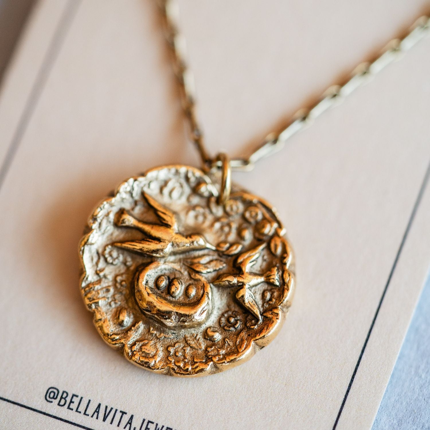 Artisan gold mama bird pendant necklace featuring vintage motherhood button casting
