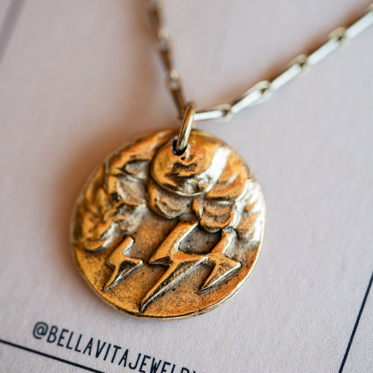 Cast gold storm cloud pendant from antique button design by Bella Vita Jewelry artisans