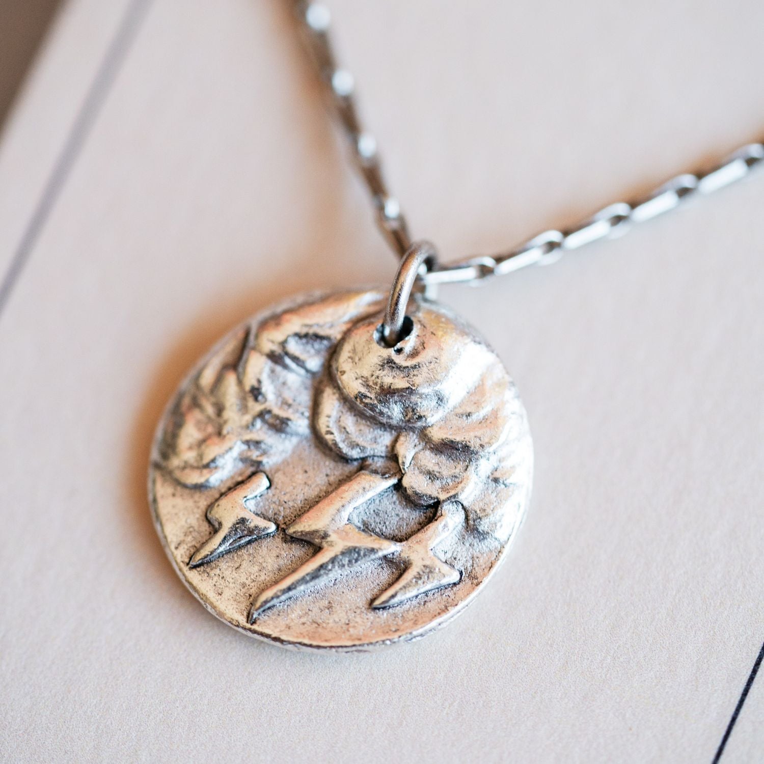 Artisan silver storm cloud pendant necklace featuring vintage weather button casting by Bella Vita