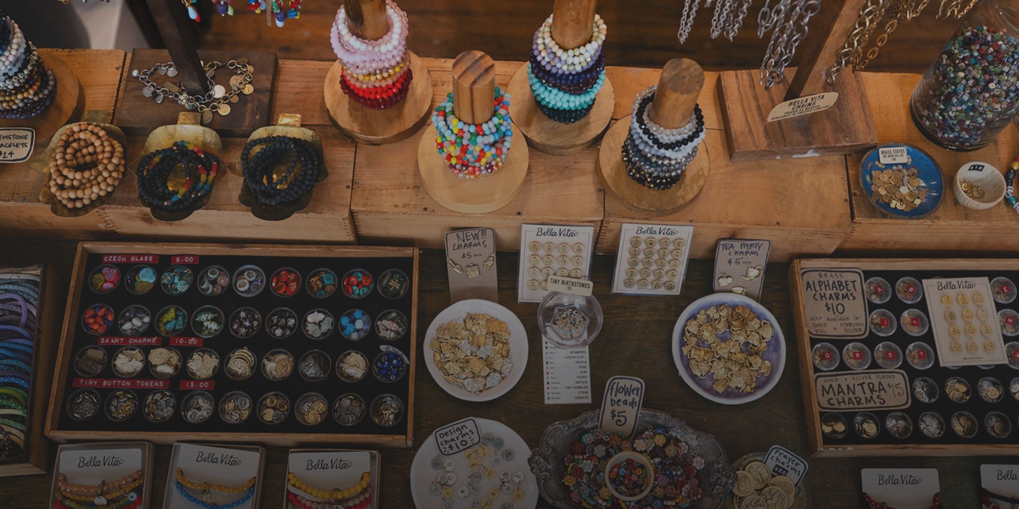 Display of custom charms, beads, and bracelets at Bella Vita, perfect for building a unique charm bracelet.