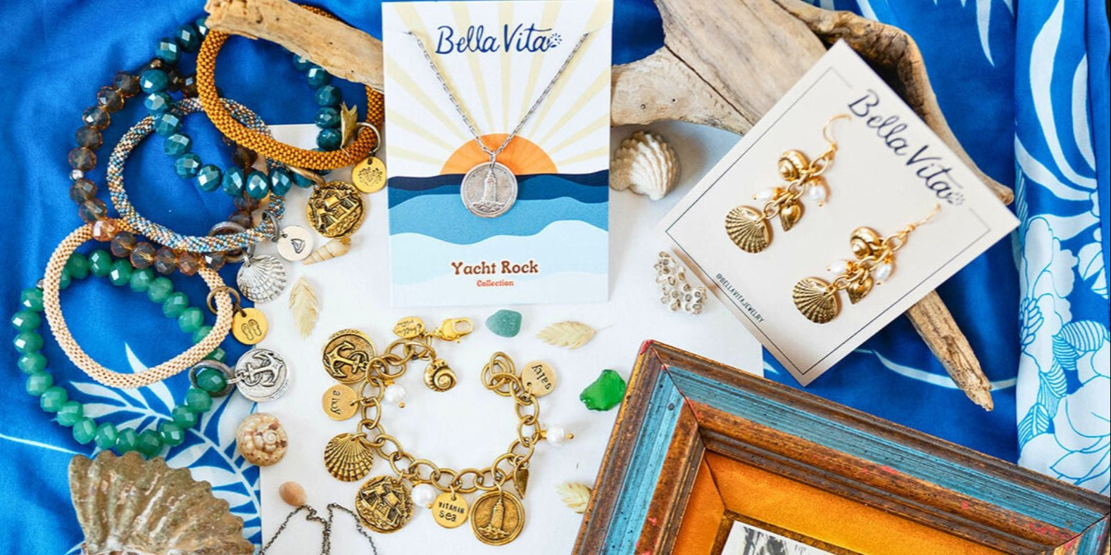 Yacht Rock Collection jewelry display featuring bracelets, necklaces, and shell earrings with packaging and nautical styling elements