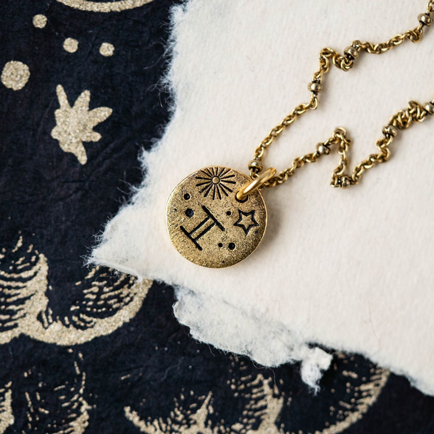 Gold Gemini zodiac pendant necklace with twins symbol and celestial engravings on chain