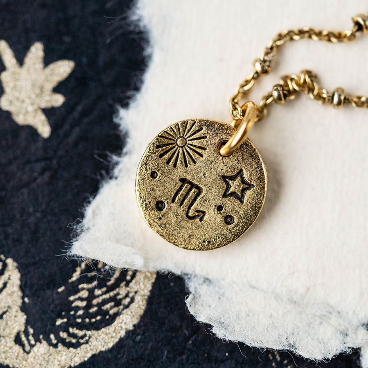 Gold chain necklace with Scorpio zodiac pendant featuring scorpion and celestial constellation symbols