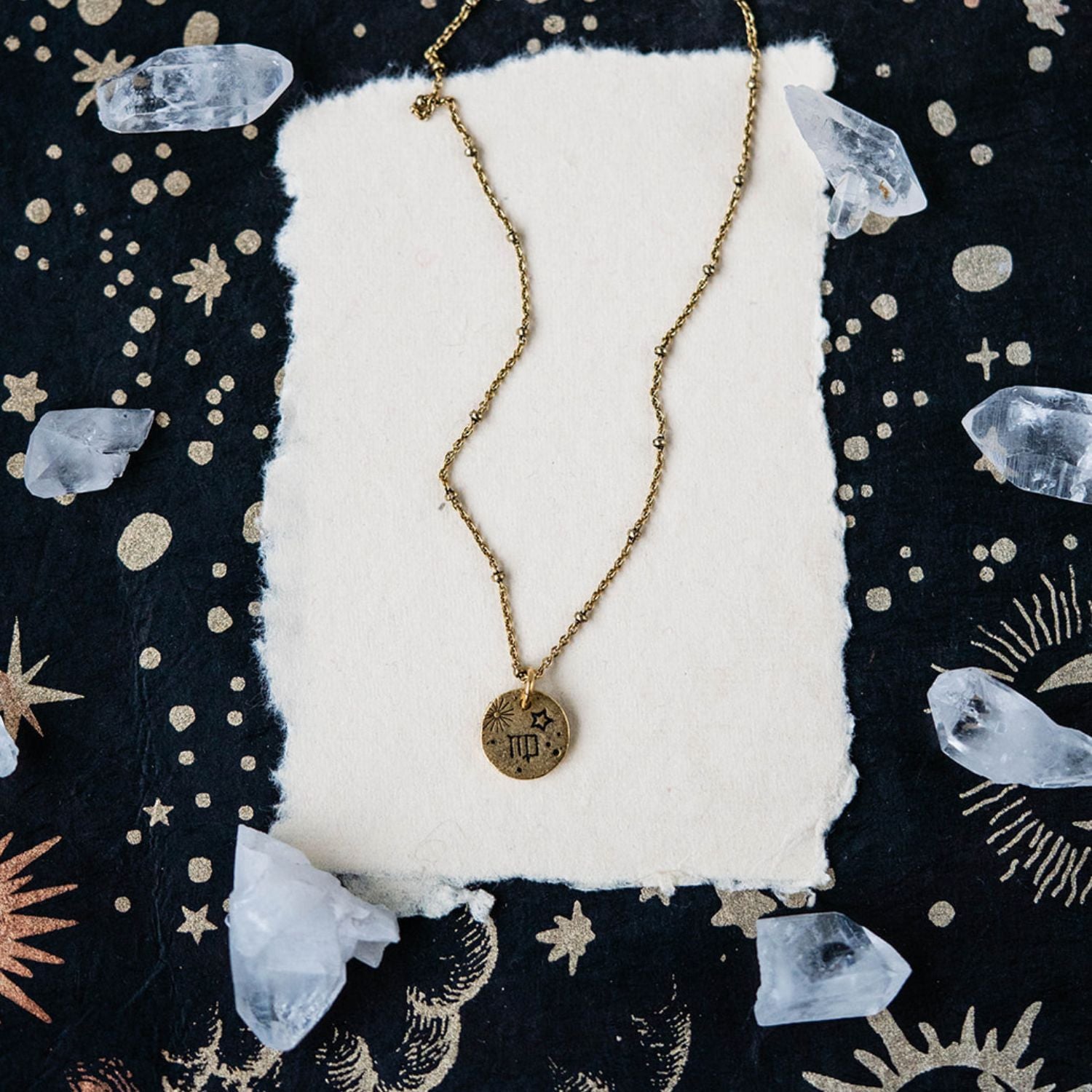 Virgo constellation charm necklace featuring gold disc with engraved harvest and star symbols